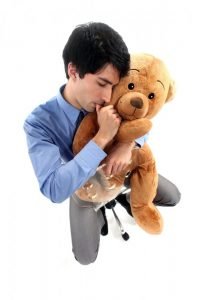 businessman-hugging-teddy-bear-and-sucking-thumb