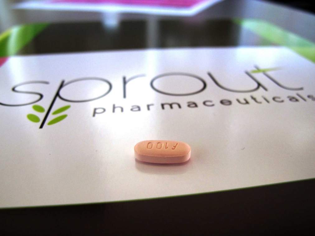 FILE - In this Friday, Sept. 27, 2013, file photo, a tablet of flibanserin sits on a brochure for Sprout Pharmaceuticals in the company's Raleigh, N.C., headquarters. The pill has been twice rejected, but Sprout Pharmaceuticals said Tuesday, Feb. 17, 2015, it is refiling its application for flibanserin, adding new information requested by the Food and Drug Administration about how the pill affects driving ability. (AP Photo/Allen G. Breed, File)